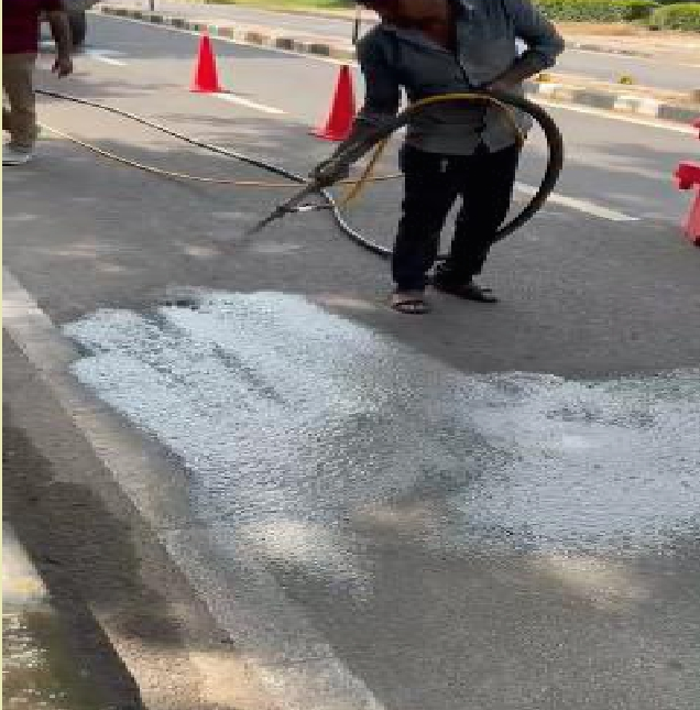 Grout application on road wearing course